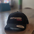 Black Flex fit baseball cap with pink embroidery slogan saying Untamed Fernie, BC