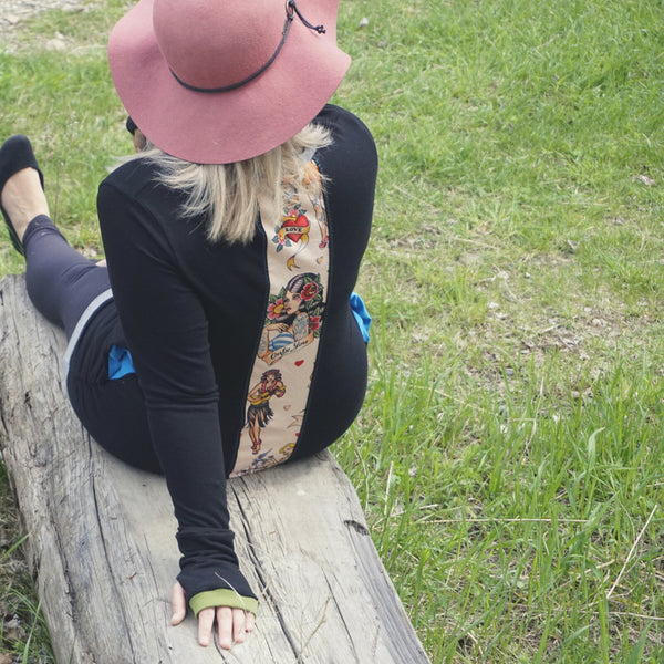 The model is wearing the sleeved sweater without a hood. It has hidden side pockets and super flattering shape.